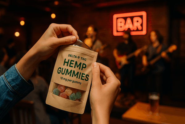 Close-up of a person opening a bag of hemp gummies labeled “Delta-9 THC Hemp Gummies” during a live concert at an Austin, Texas bar — representing local cannabis edible delivery and nightlife culture.